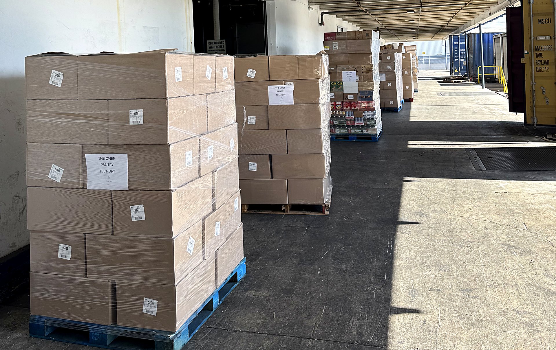 Customer pallets staged for Caribbean export at Roman Wholesale's Miami dock